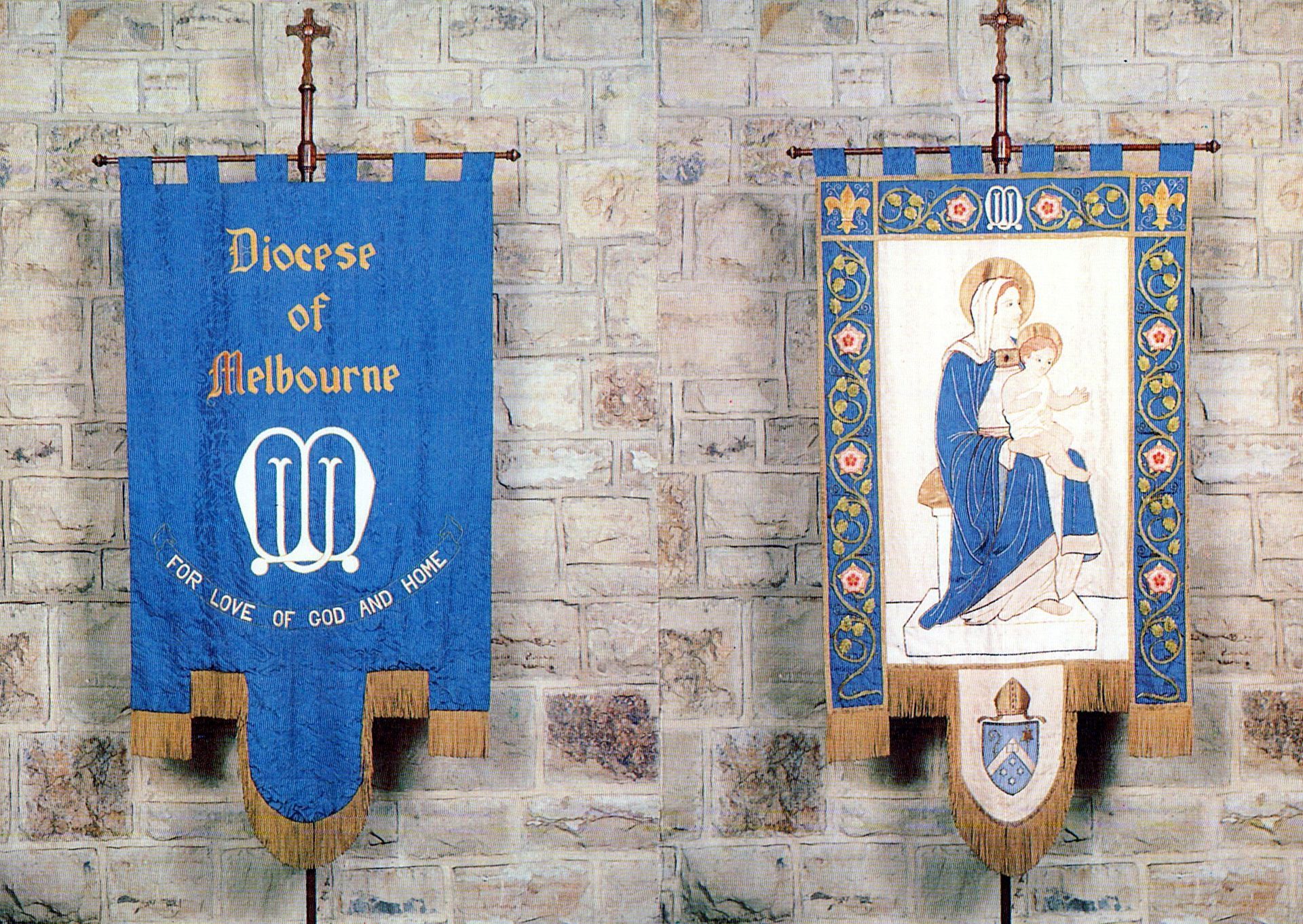 Two blue banners hanging on a brick wall one says diocese of melbourne