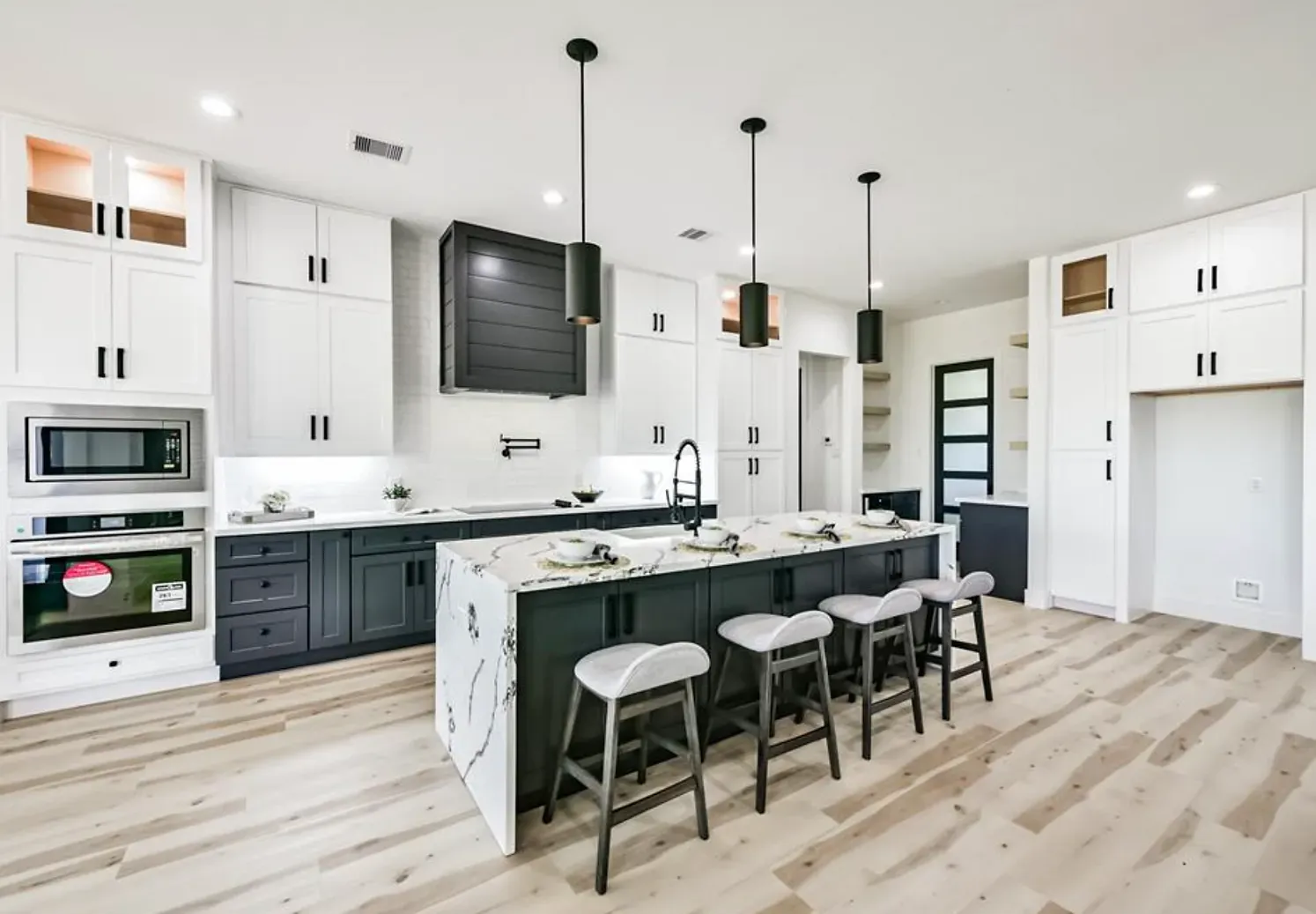 A large kitchen with a large island and stools.