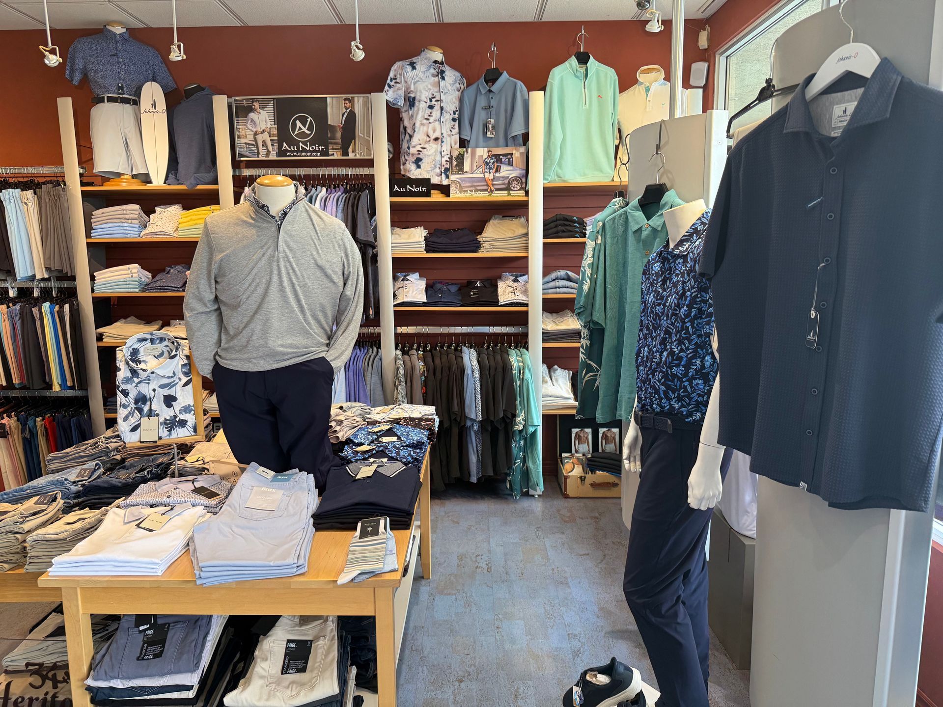 Coordinated wardrobe with suits, shirts and shoes at a men's clothing store
