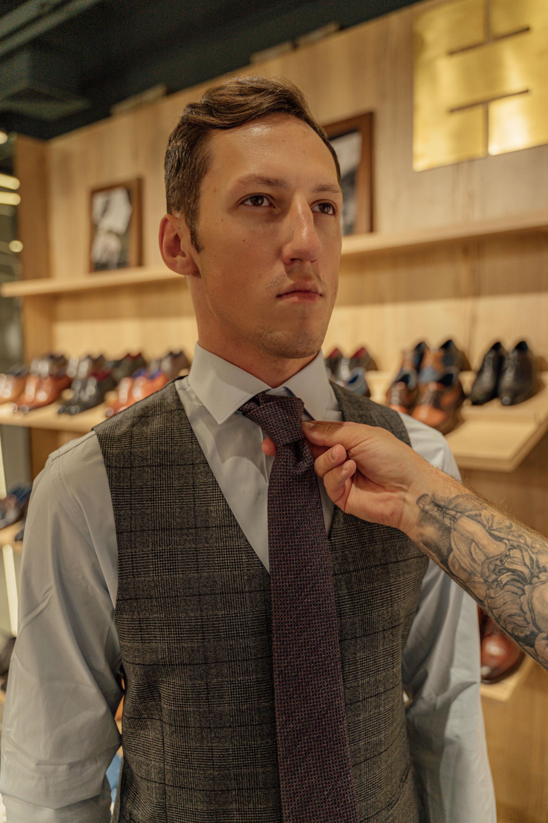 a man getting a custom fitting for his clothing