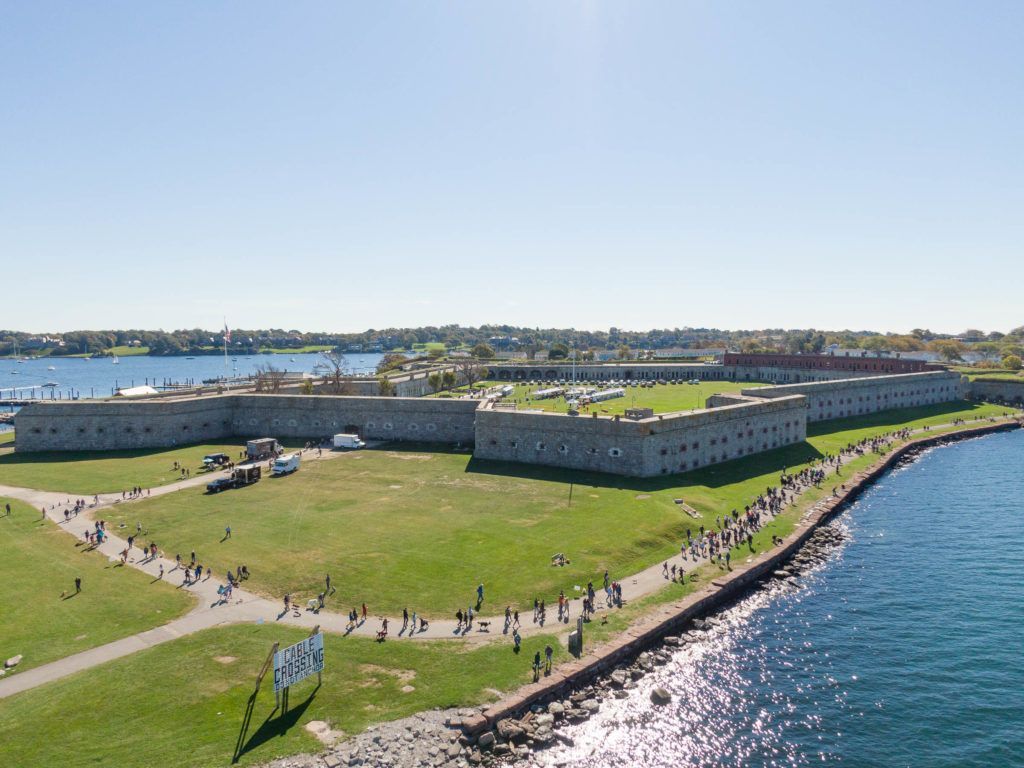 An aerial view of a large building next to a body of water.