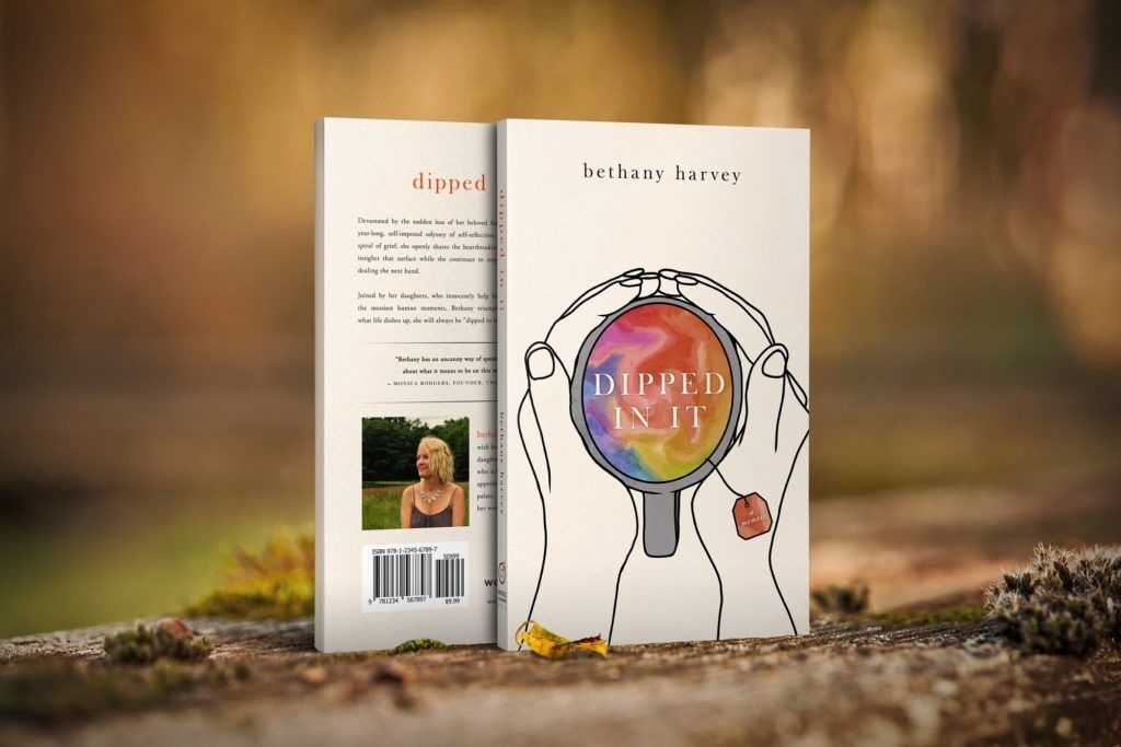 A book with a magnifying glass on the cover is sitting on a rock.