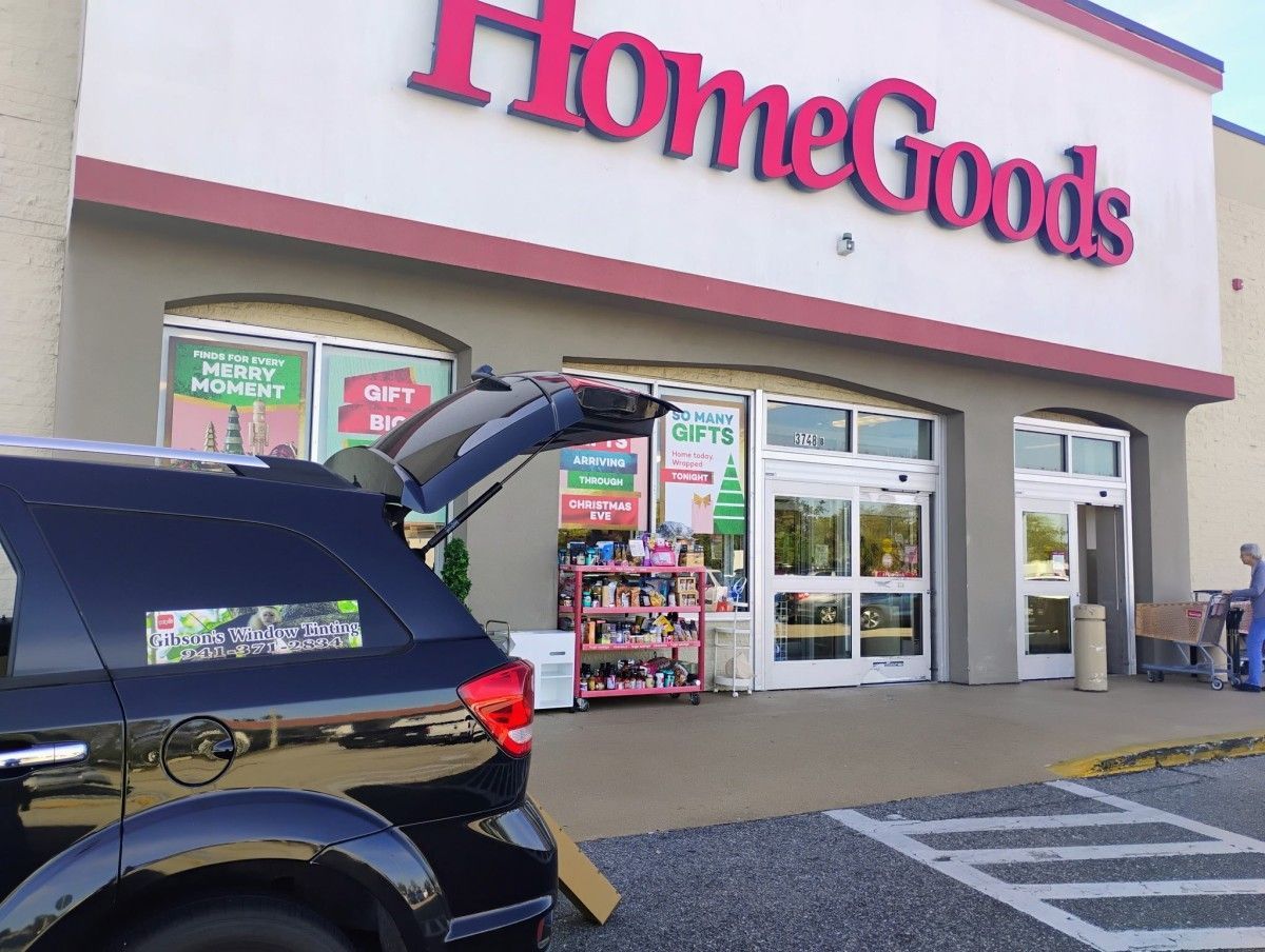 HomeGoods storefront with parked SUV and shopping carts outside