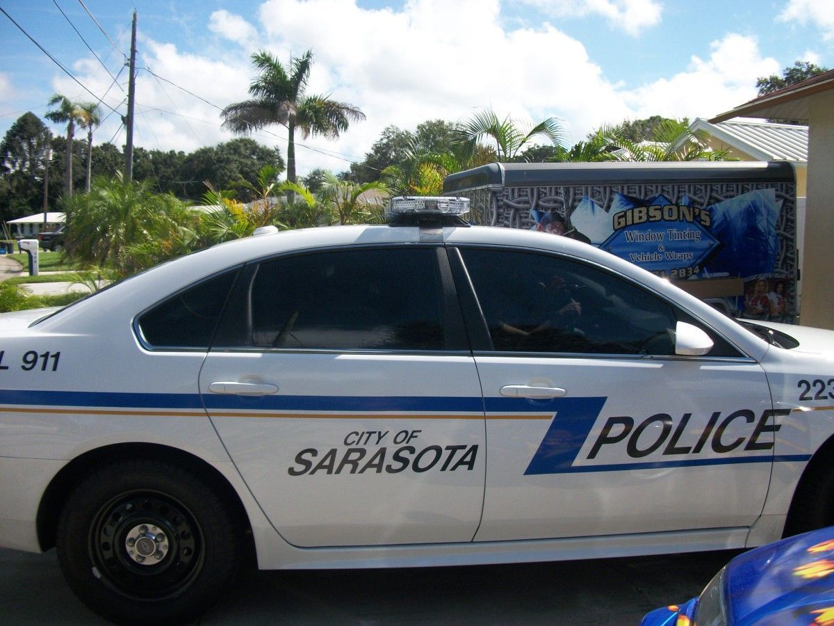 City of Sarasota police car parked outdoors under a sunny sky