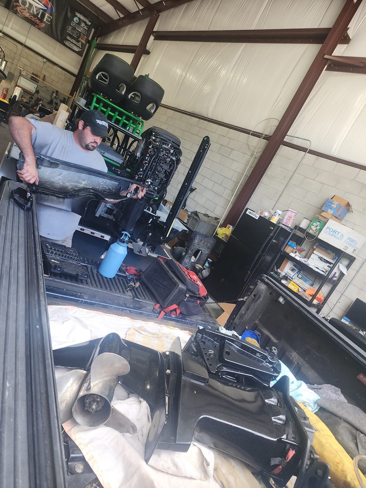 A mechanic is working on a car engine with a wrench.