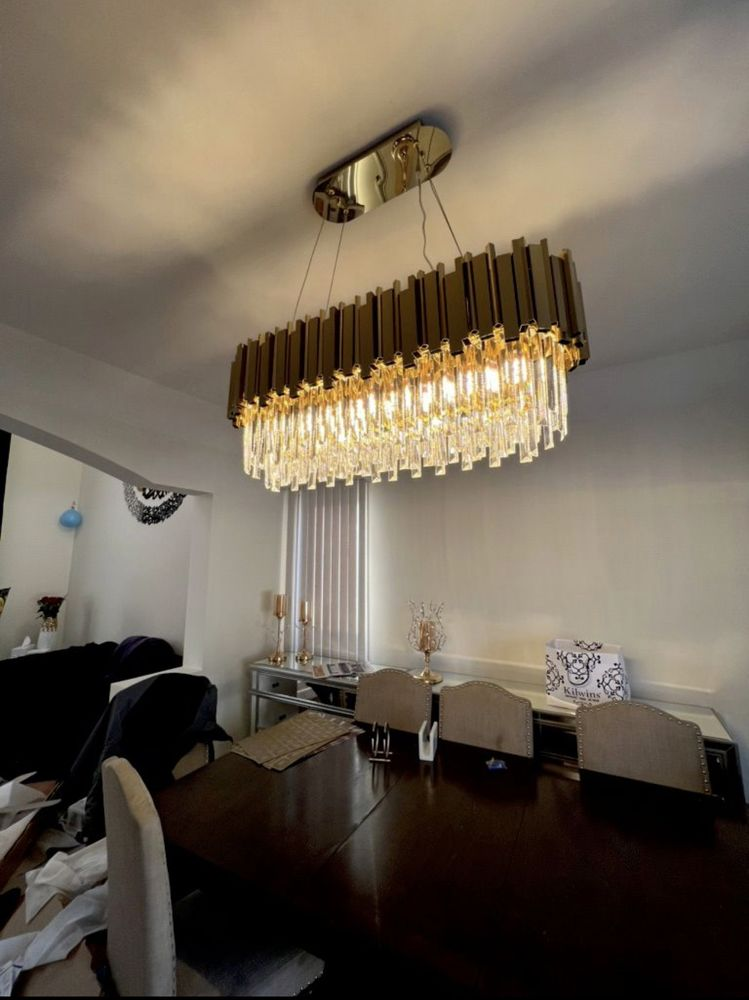 Rectangular chandelier over a dining table, chrome and crystal. Brown shade.