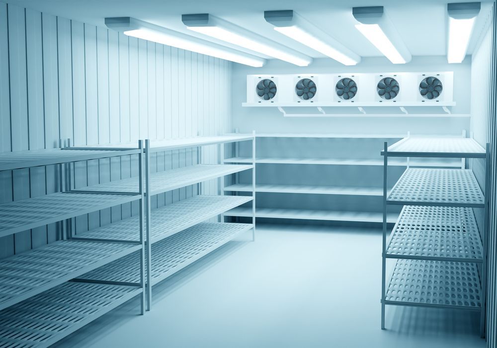 Empty commercial refrigerator room with metal shelves and cooling units. — Leader Air Conditioning in Albury/Wodonga, VIC