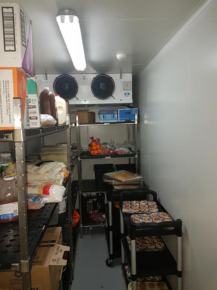 A Walk-In Refrigerator Interior with Shelving — Leader Air Conditioning in Wagga Wagga, NSW
