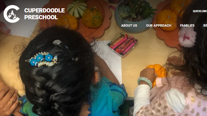 Children seated on floor using crayons and paper in a preschool classroom task