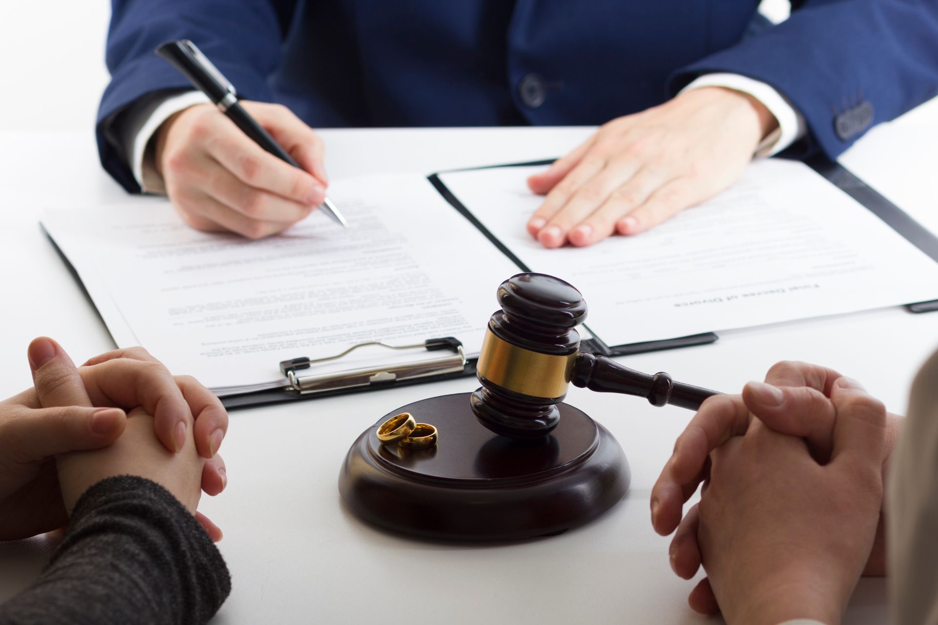 Couple signing divorce or separation documents prepared by a lawyer. Couple signing divorce or separation documents prepared by a lawyer.