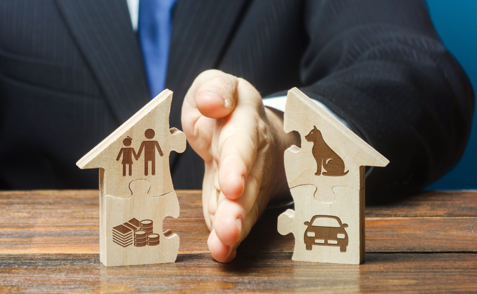 Divorce law concept with assets divided between two household models.