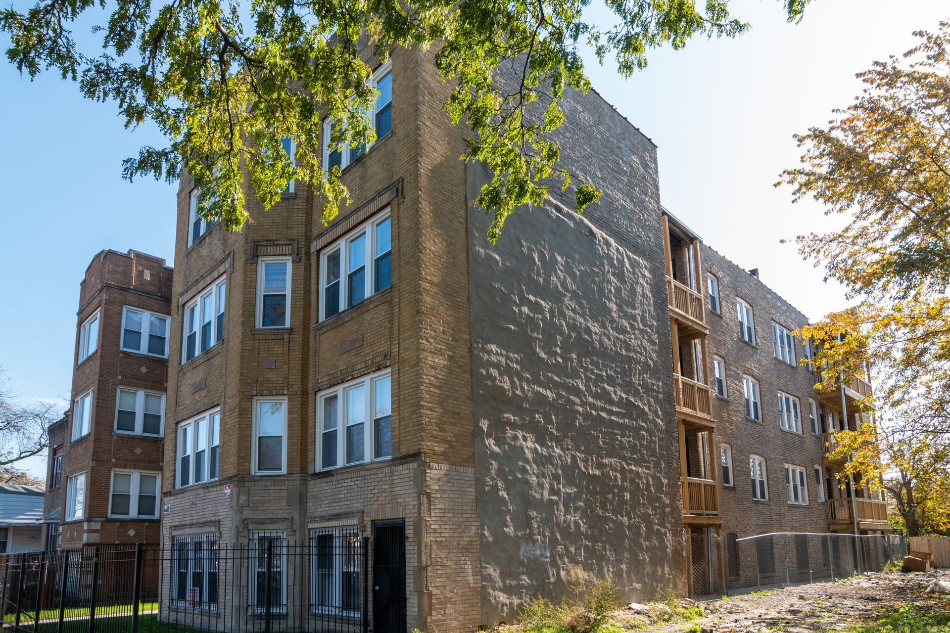 Multi-story brick apartment building under construction.