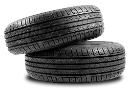 Two black car tires stacked on a white background | Tiny's Tire Center