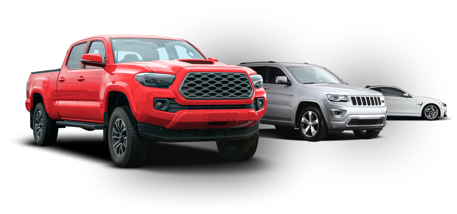 Three pickup trucks lined up, with a red truck in front and gray and white trucks behind. | Tiny's Tire Center
