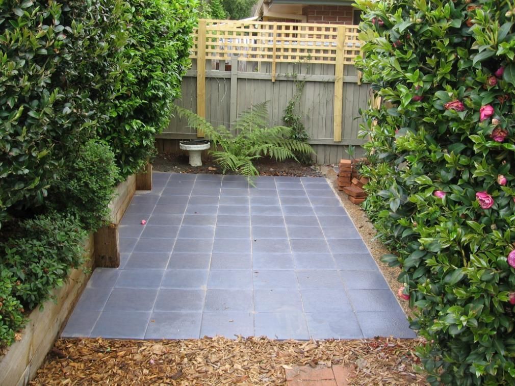 A Garden With a Fence and a Tiled Floor — Seascapes Landscape Construction in Laurieton, NSW