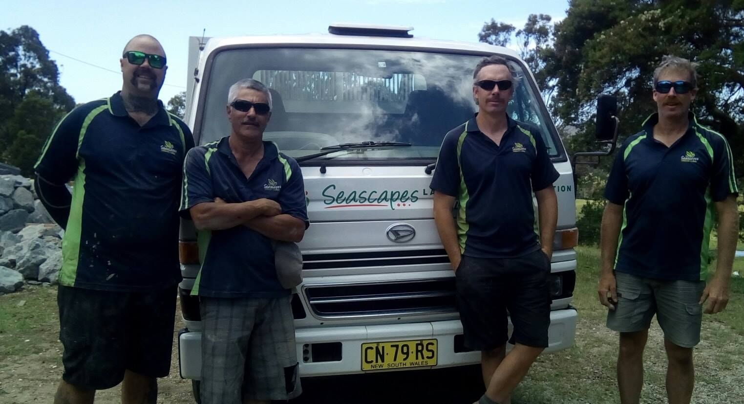 A Group of Men Standing in Front of a White Truck With Licence Plate Ln 7975 — Seascapes Landscape Construction in Kendall, NSW
