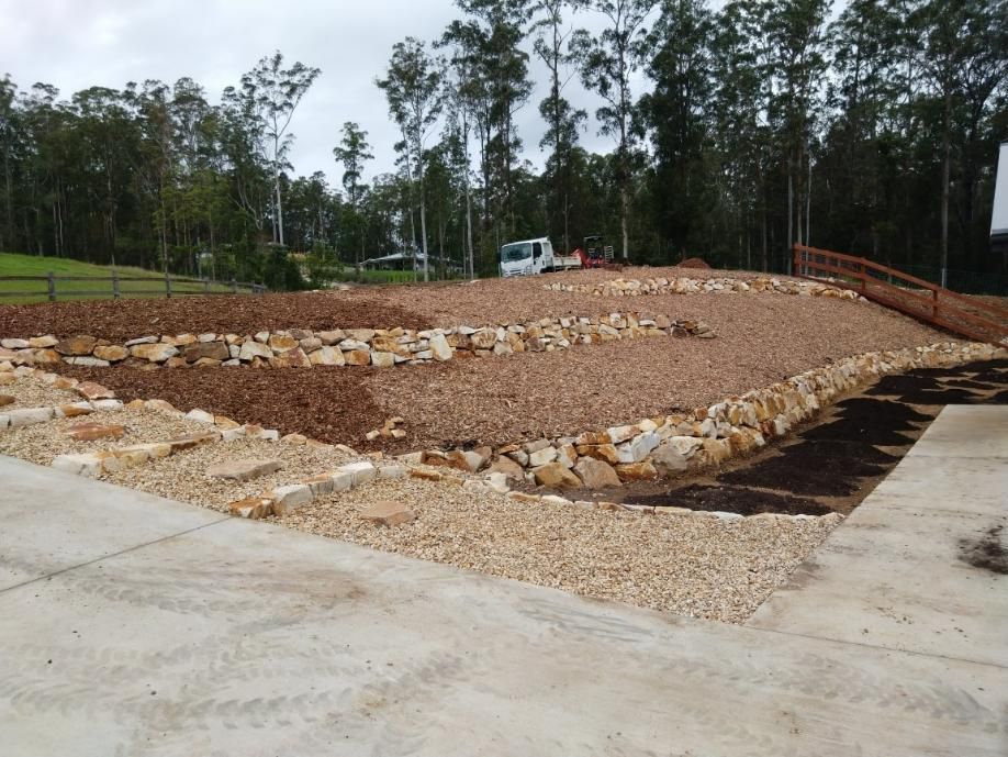 A Gravel Driveway With Trees in the Background — Seascapes Landscape Construction in Lake Cathie, NSW