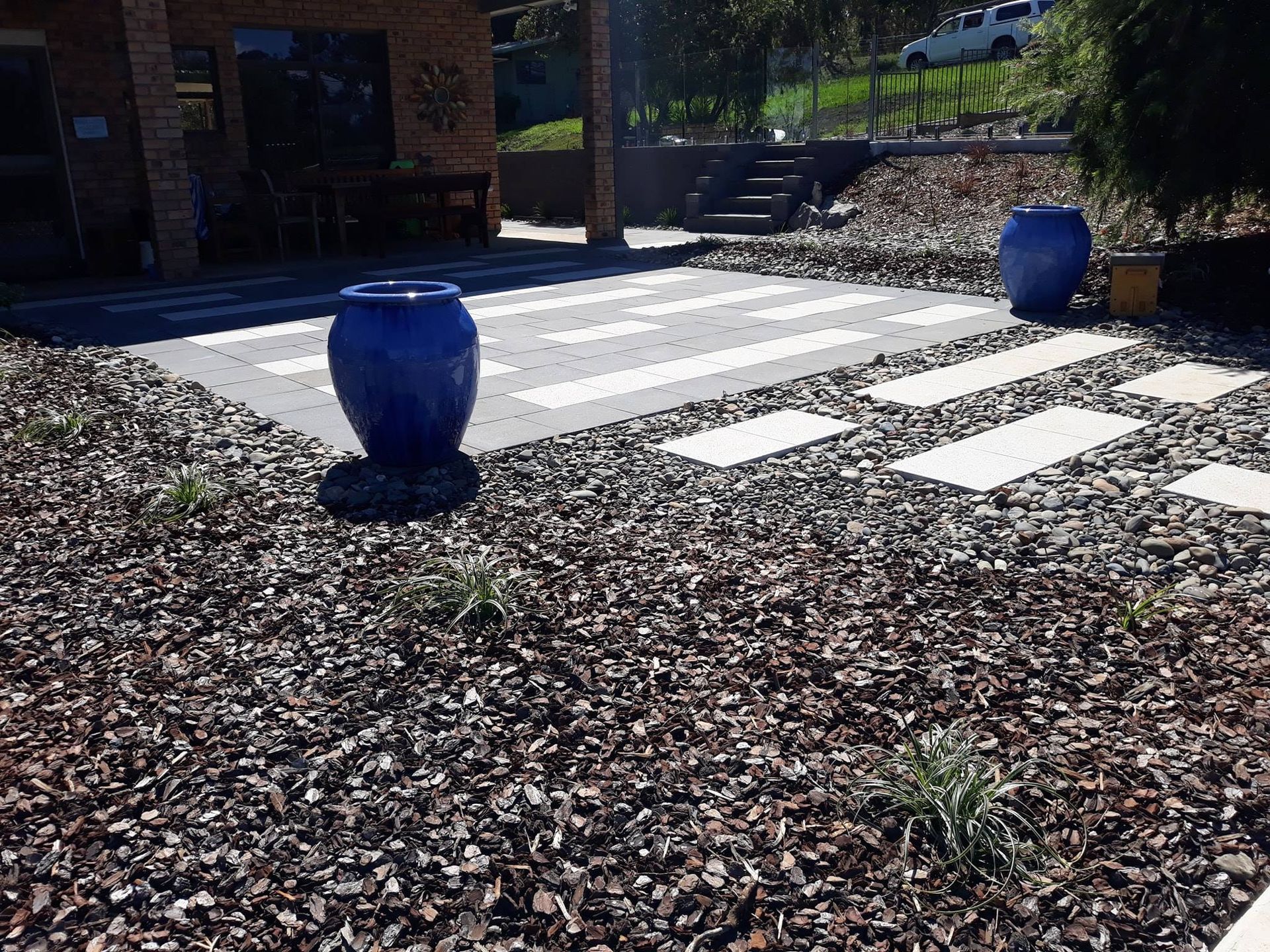 A Blue Pot is Sitting on Top of a Pile of Gravel — Seascapes Landscape Construction in Port Macquarie, NSW