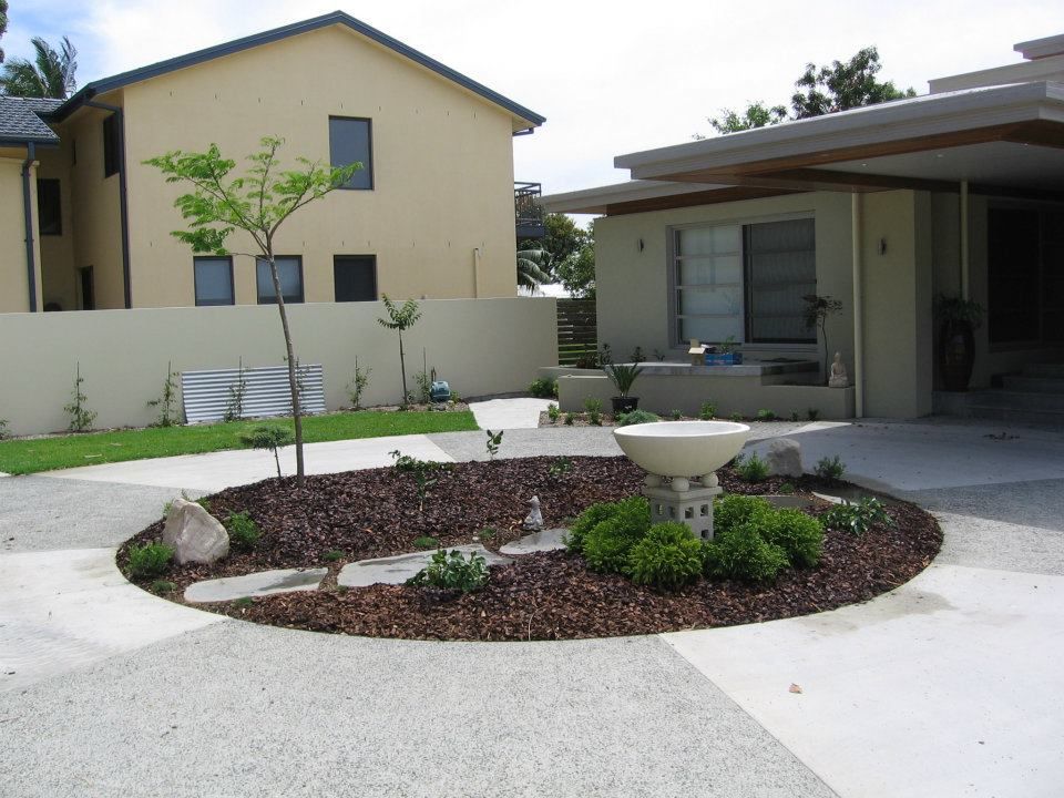 A House With a Circular Garden in Front of It — Seascapes Landscape Construction in Kendall, NSW