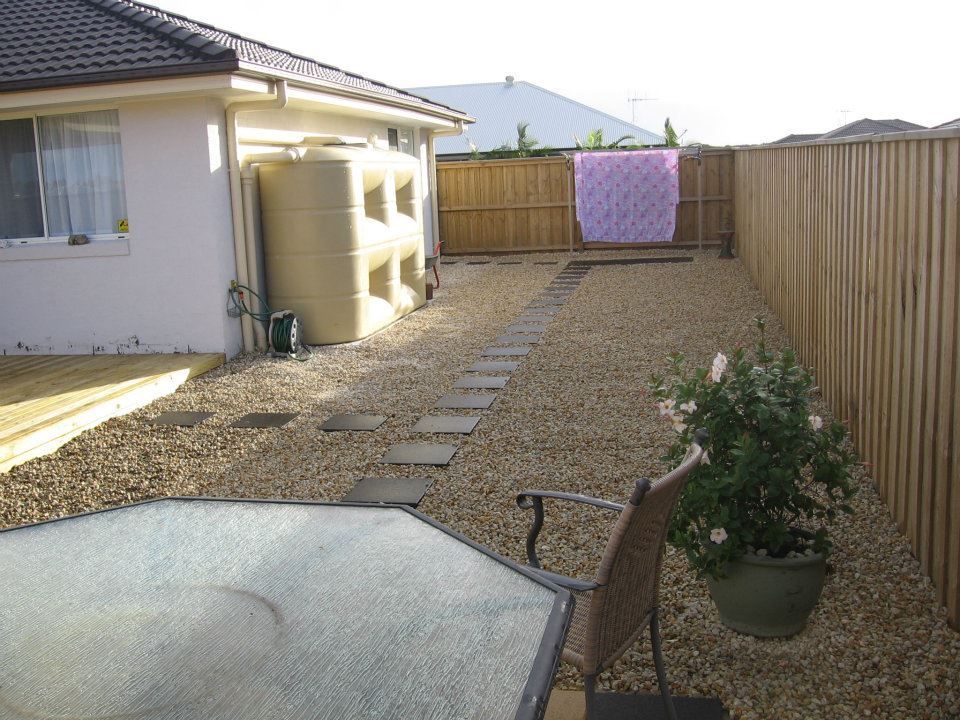 A Backyard With a Table and Chairs and a Fence — Seascapes Landscape Construction in Kendall, NSW
