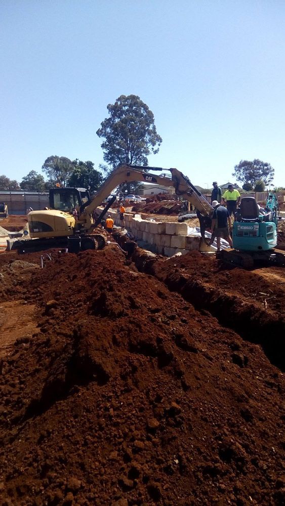 A Large Pile of Dirt is Being Excavated on a Construction Site — Seascapes Landscape Construction in Laurieton, NSW