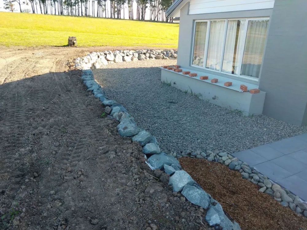 A House With a Gravel Driveway in Front of It — Seascapes Landscape Construction in Kendall, NSW