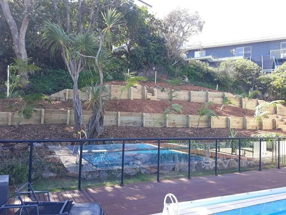 A Green Tarp is Covering a Dirt Area in Front of a House — Seascapes Landscape Construction in Kendall, NSW