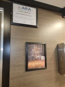A bathroom with a hanging pictures