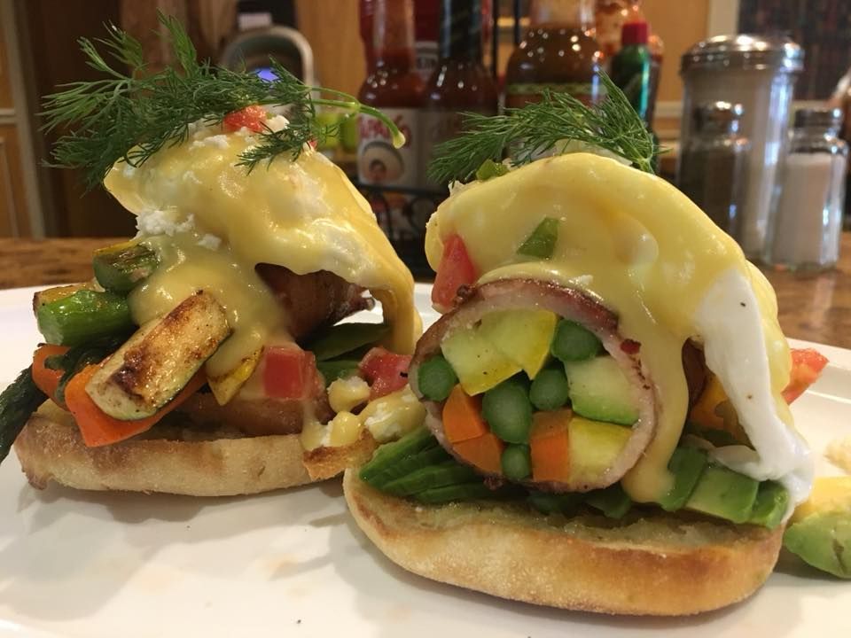 A close up of two sandwiches on a white plate on a table.