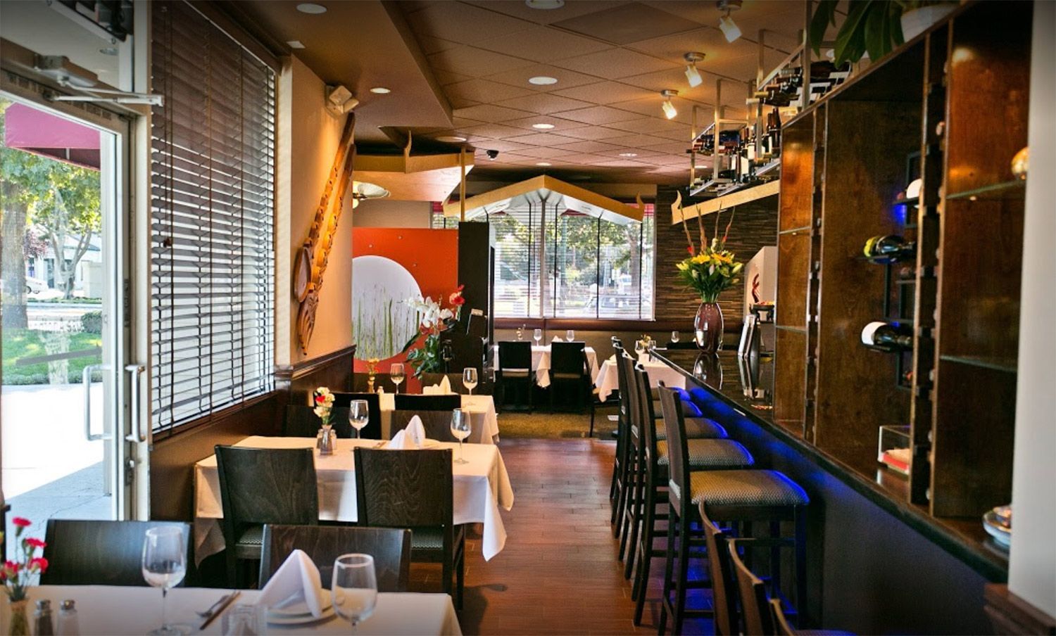 A restaurant with tables and chairs and a bar