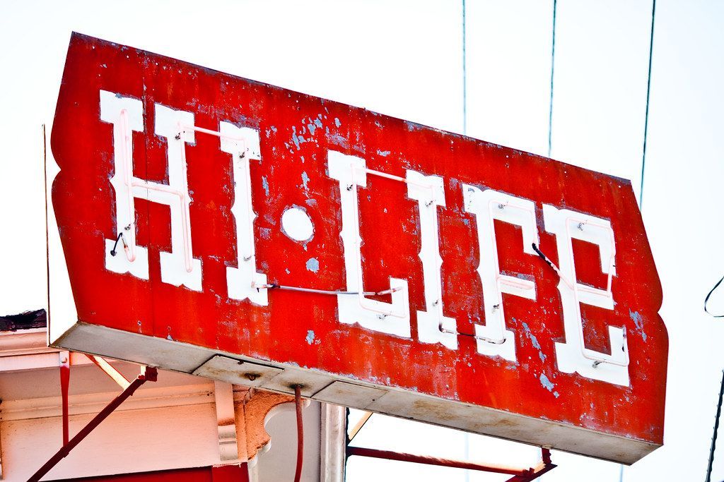 A red sign that says hi-life on it