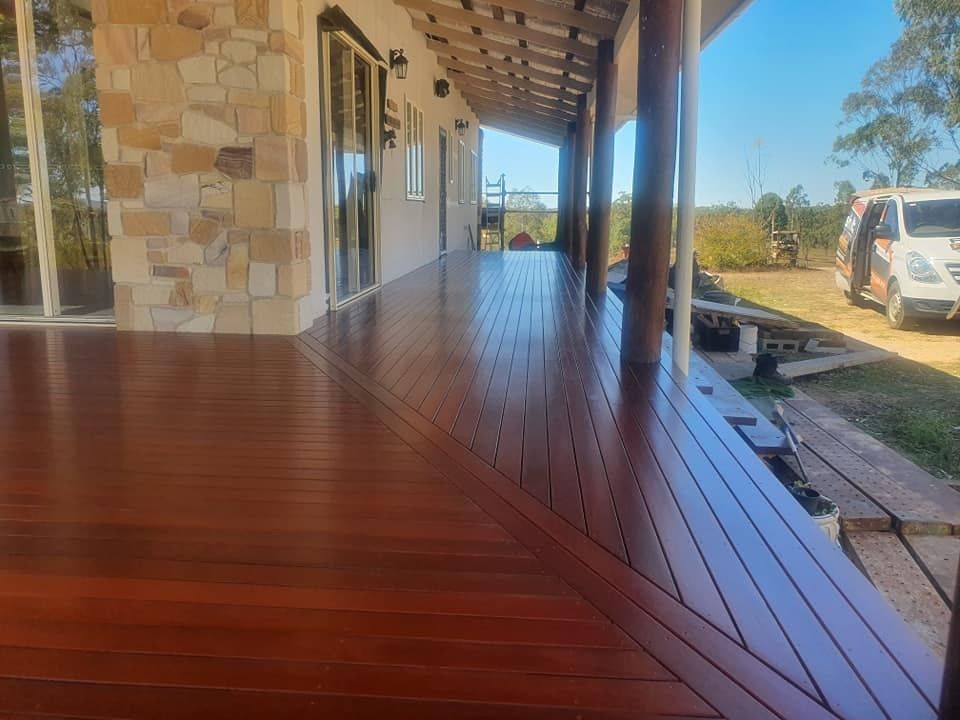 A Large Wooden Deck with A Car Parked in Front of It — Finish It Floor Sanding in Bucca, QLD