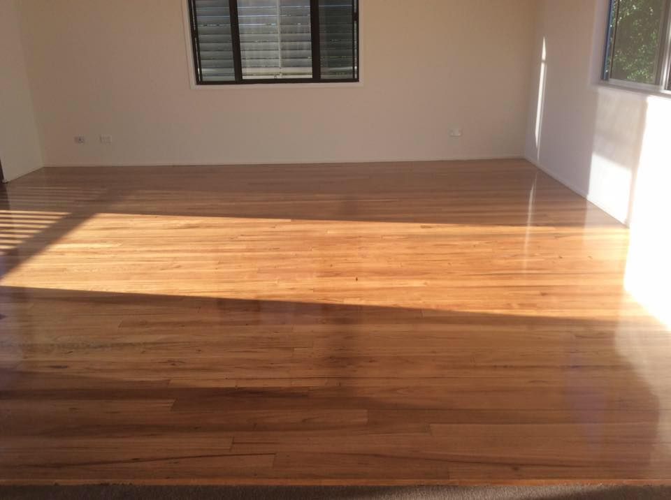 A Living Room with Hardwood Floors and A Window — Finish It Floor Sanding in Bucca, QLD