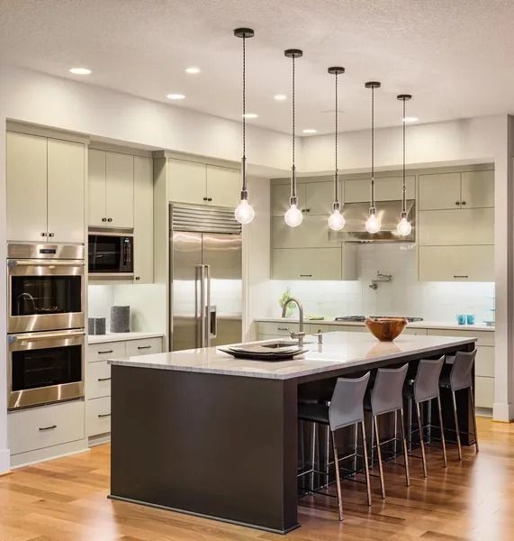 A Kitchen with Stainless Steel Appliances and A Large Island — Finish It Floor Sanding in Bundaberg, QLD