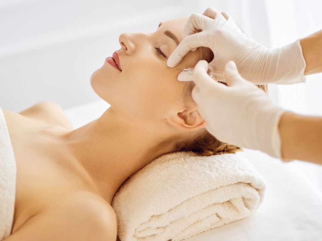 A woman is getting a facial treatment at a spa.
