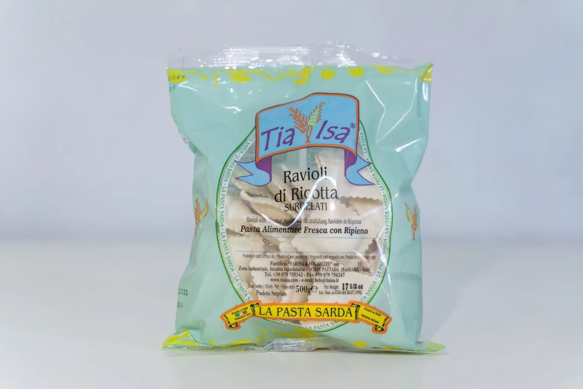 Confezione blu di pasta con dettagli gialli e una finestra trasparente che mostra i ravioli all’interno