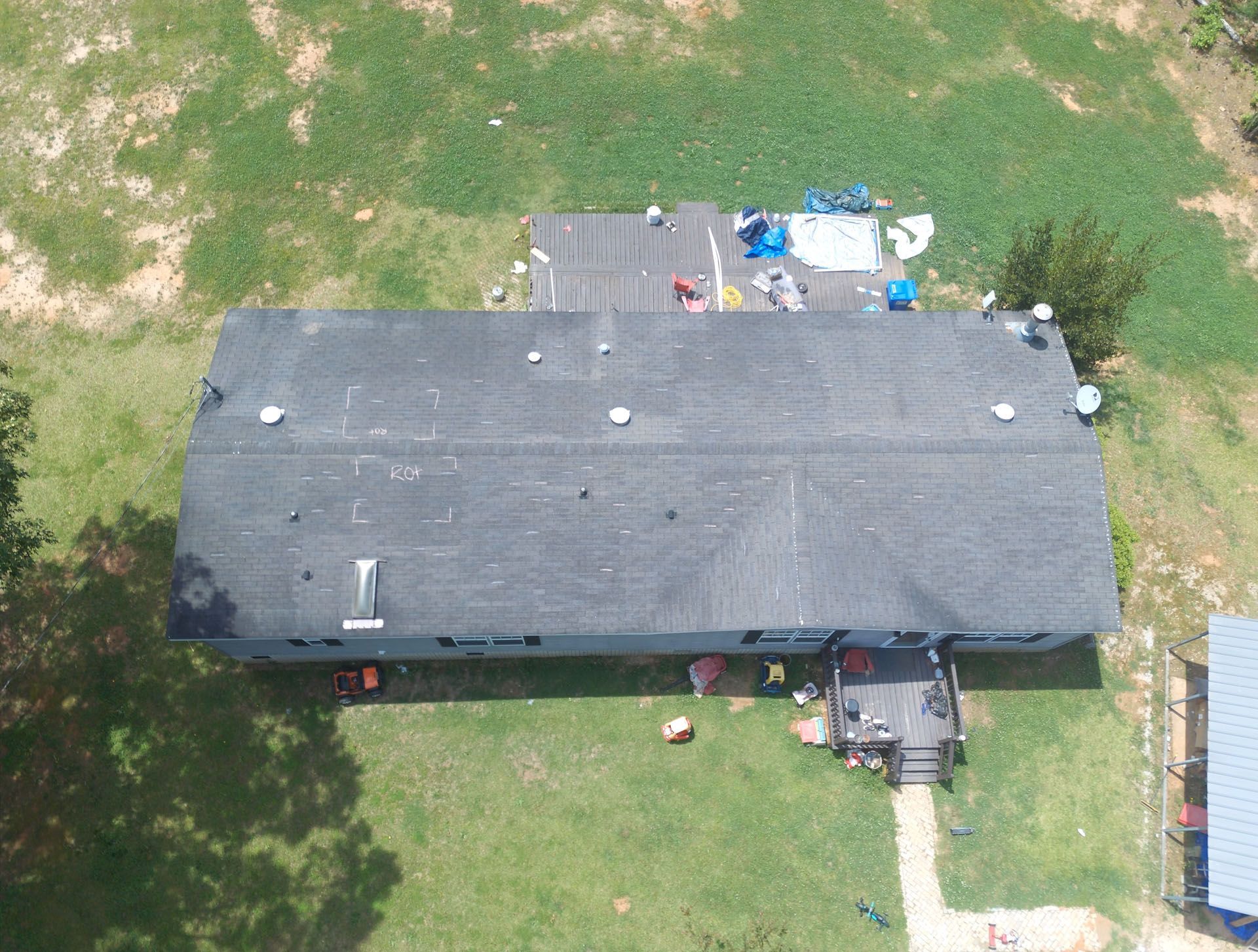 An aerial view of a house with a roof that is being repaired.