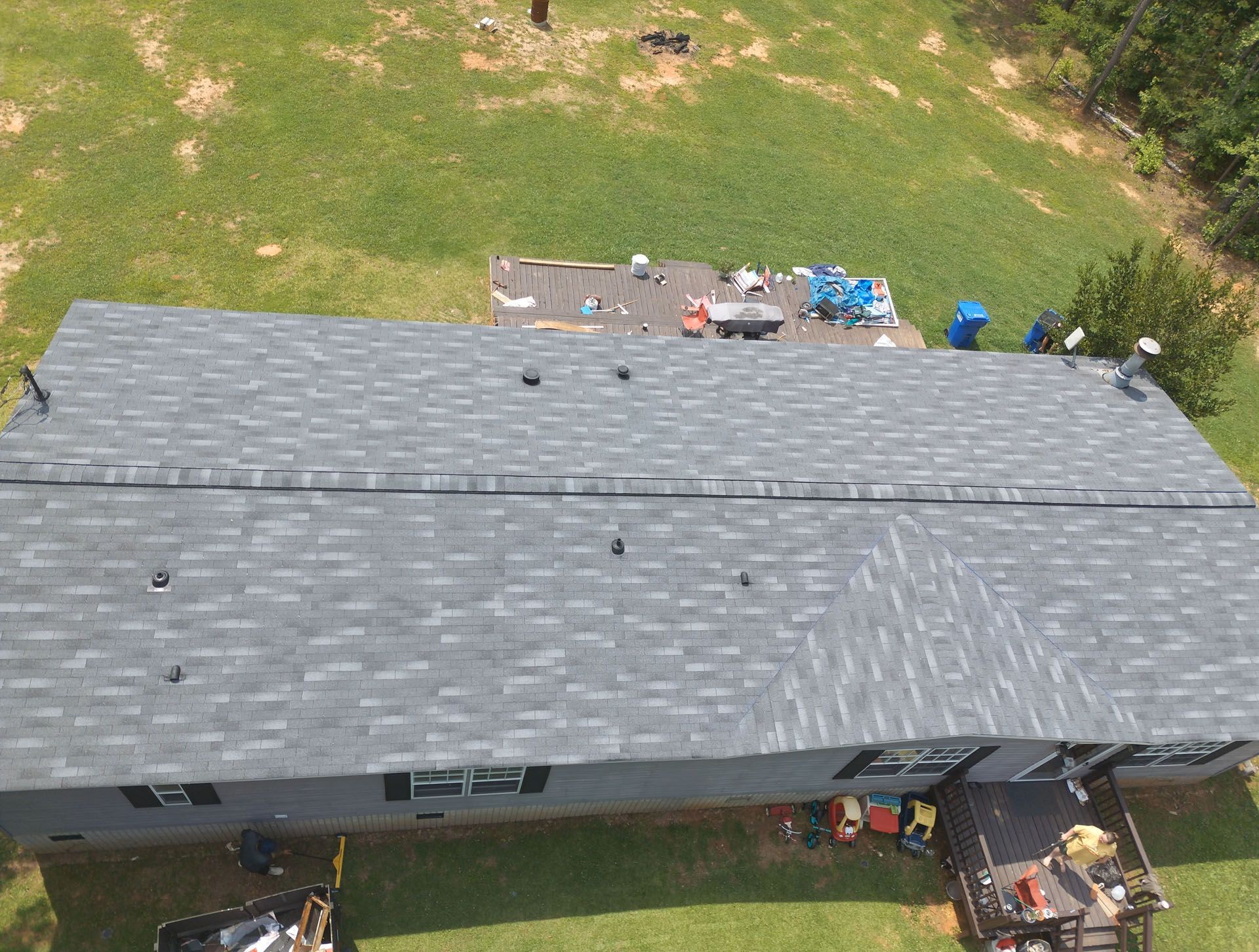An aerial view of a house with a roof being installed.