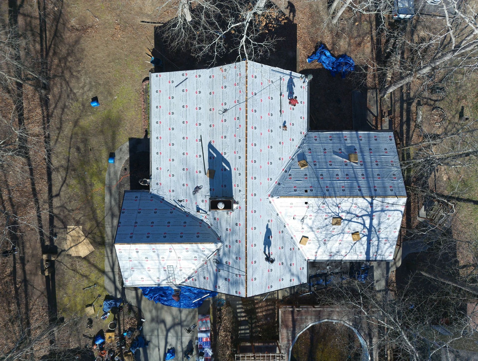An aerial view of a house with a roof being installed.