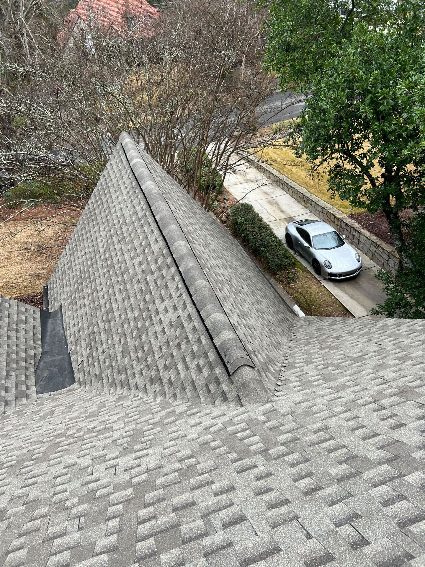 A car is parked on the roof of a house.