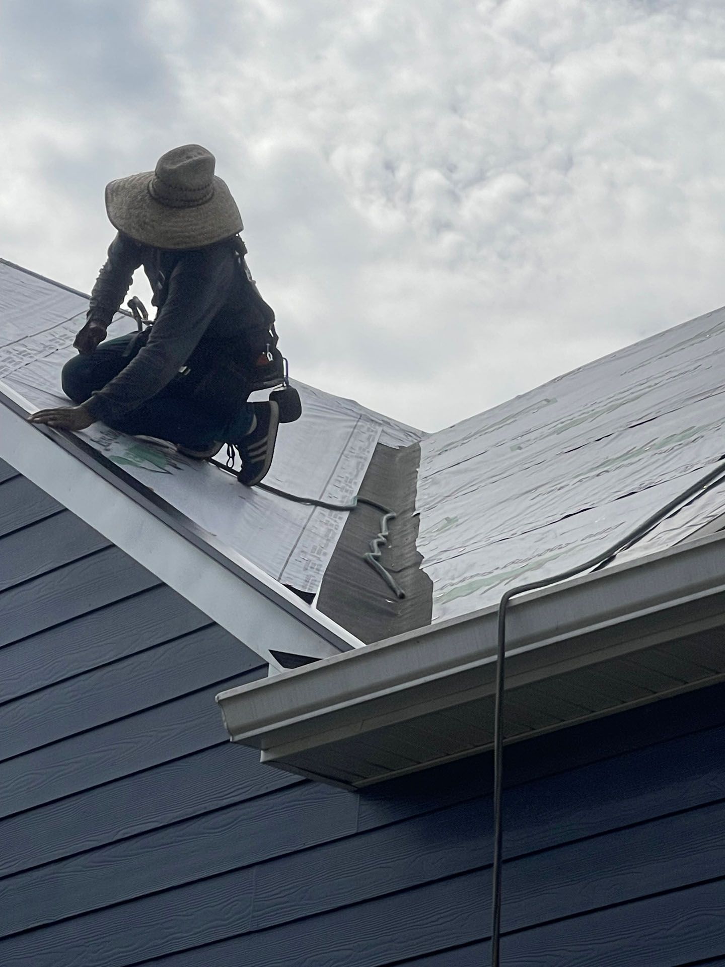 A man is working on the roof of a building.