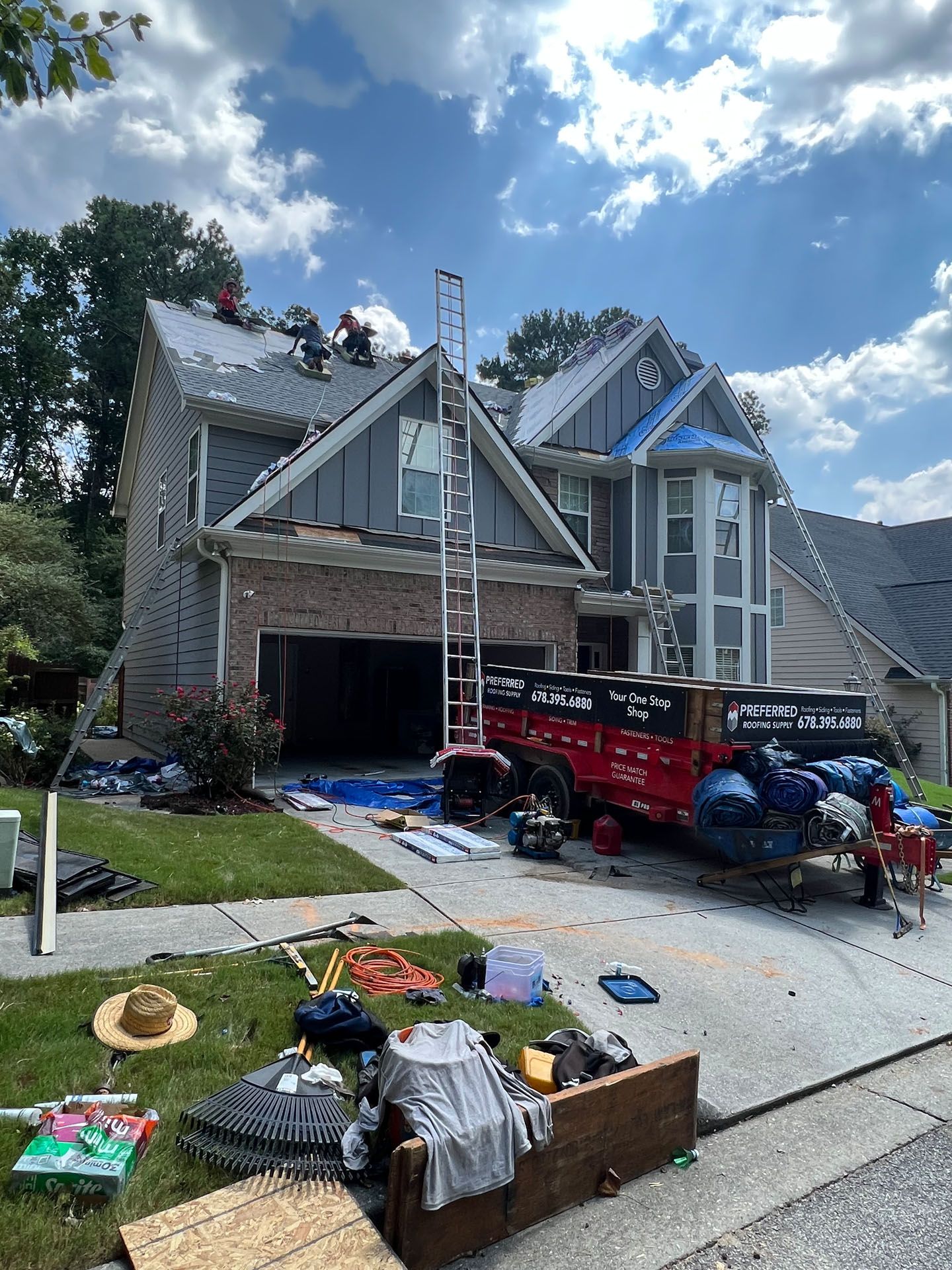 A house is being remodeled with a truck parked in front of it.