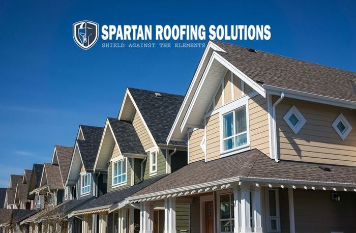 A row of houses with spartan roofing solutions written on the bottom