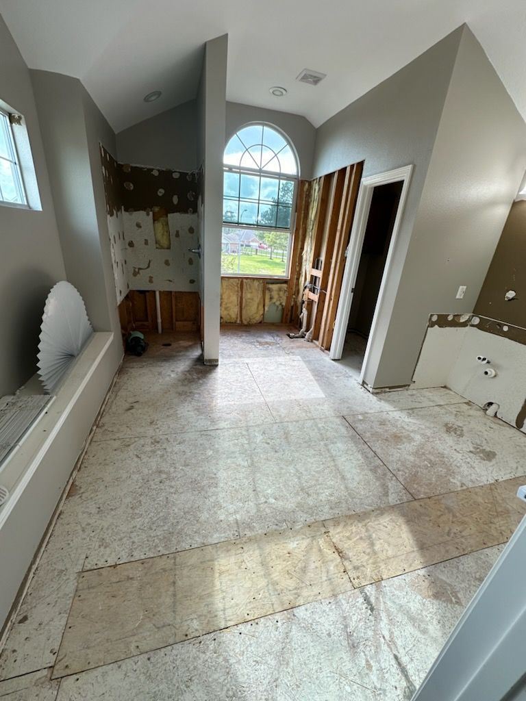 A bathroom under construction with a large window and a bathtub.