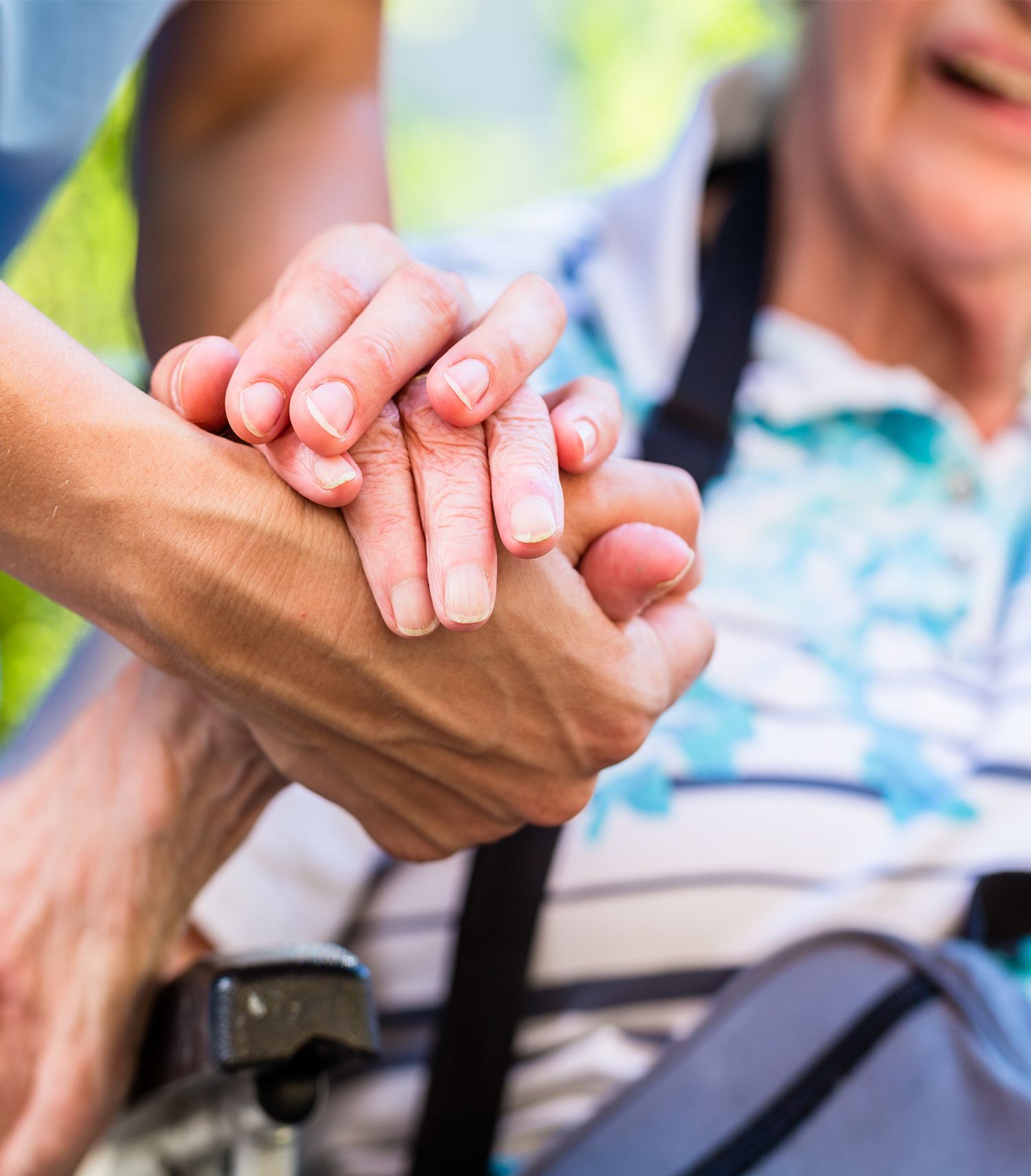 Close up image of a person holding another persons hand in support
