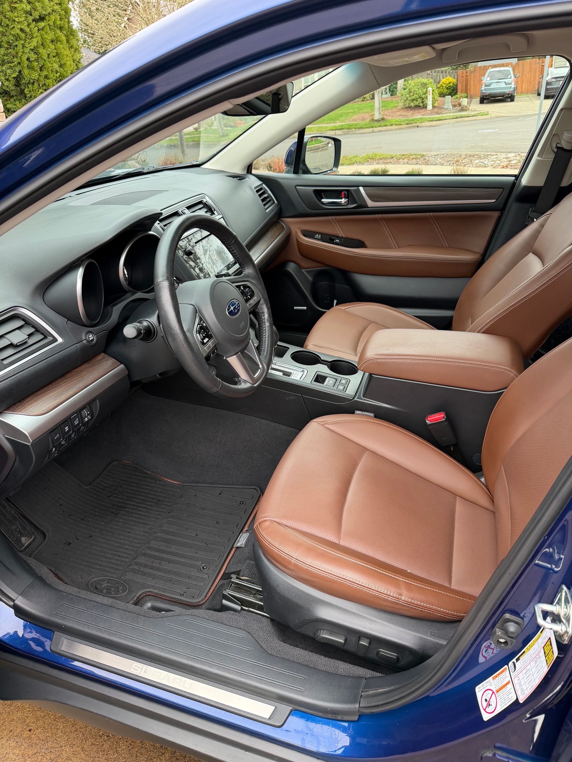 Blue Subaru Outback interior with brown leather seats.