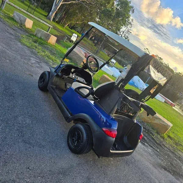 Blue Golf Cart Parked on a Paved Lot at Sunset — Lift It Equipment in Tuggerah, NSW