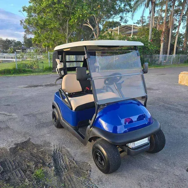 Blue Golf Cart Parked on Pavement Beside a Sandy Area — Lift It Equipment in Tuggerah, NSW
