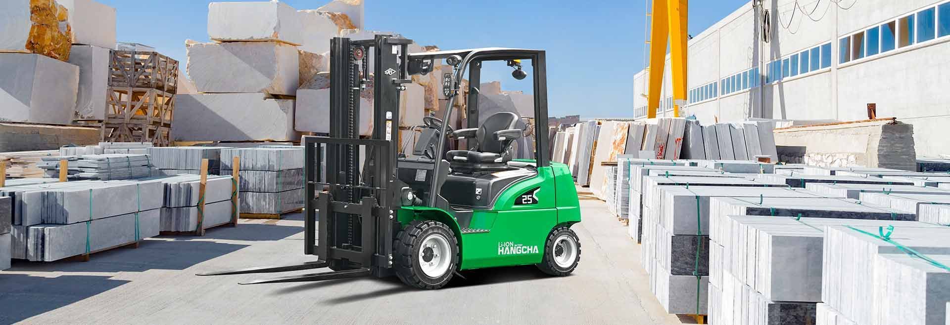 Green Forklift Moving Among White Stone Blocks in an Industrial Yard — Lift It Equipment in Tuggerah, NSW