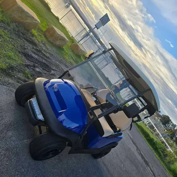 Blue Golf Cart Parked on a Paved Road Beside a Field — Lift It Equipment in Tuggerah, NSW